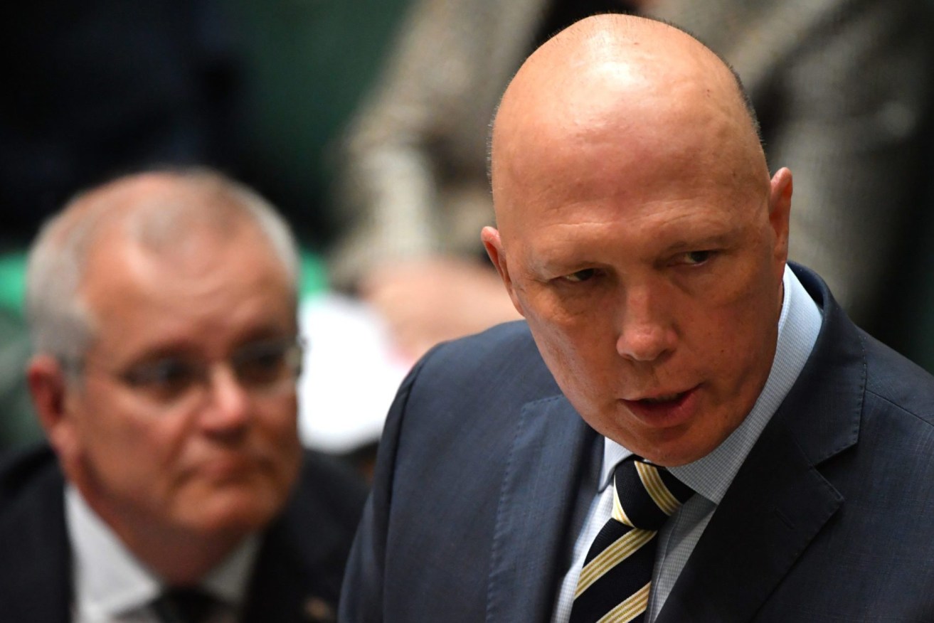 The ghost of Scott Morrison continues to follow Peter Dutton as he wins only 26 per cent of the vote in disastrous latest poll  (AAP Image/Mick Tsikas) 
