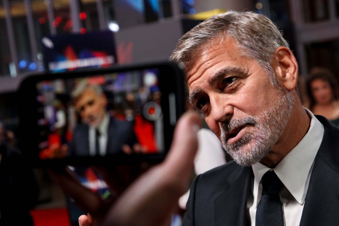 George Clooney is interviewed upon arrival at the premiere of the film 'The Tender Bar' during the 2021 BFI London Film Festival in London, Sunday, Oct. 10, 2021. (Photo by Vianney Le Caer/Invision/AP)