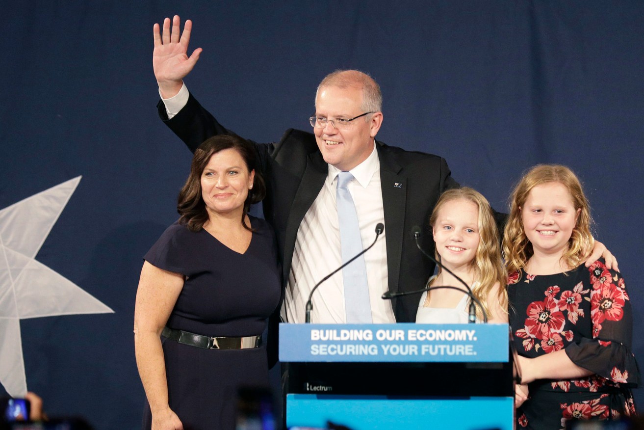 Australian Prime Minister Scott Morrison arrives on stage to speak to party supporters flanked by his wife, Jenny, left, and daughters Lily, and Abbey, right, after his opponent concedes in the federal election on May 19, 2019. (AP Photo/Rick Rycroft)
