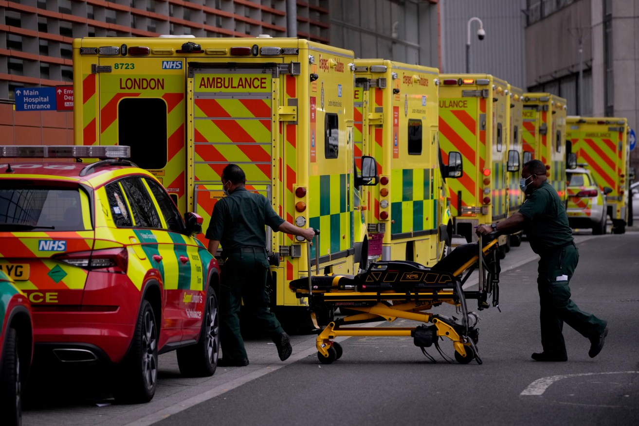 Paramedics push a trolley next to a line of ambulances outside the Royal London Hospital in the Whitechapel area of east London. (AP Photo/Matt Dunham)