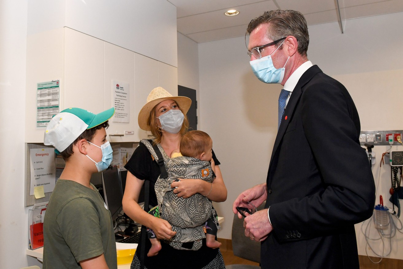 NSW Premier Dominic Perrottet speaks to a family after their child has received a COVID-19 vaccination at the Sydney Children’s Hospital. (AAP Image/Bianca De Marchi) 