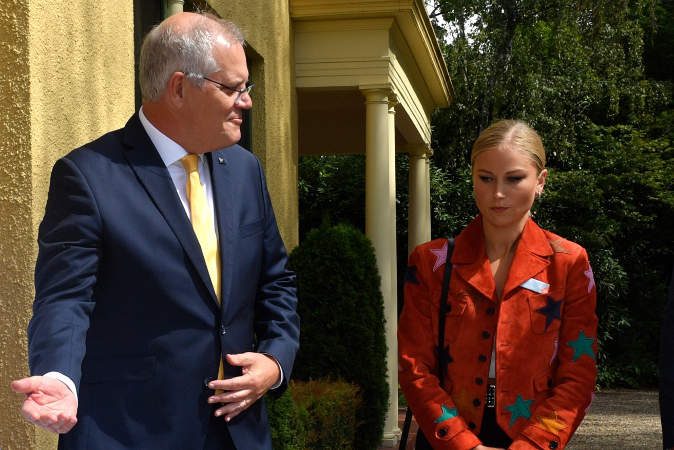 Prime Minister Scott Morrison with Grace Tame on the day before Australia Day, 2022. (AAP Image/Mick Tsikas)