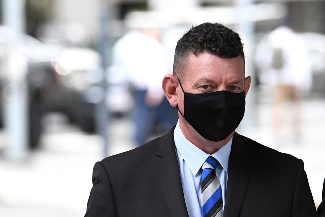 QPS detective Bryan Anthony Swift arrives at the Brisbane Magistrates Court. (AAP Image/Darren England) 