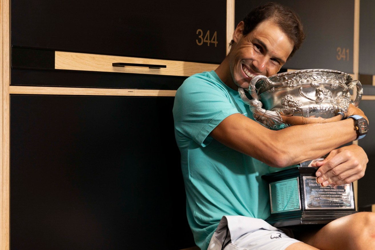 Rafael Nadal poses with the Australian Open men’s singles final trophy in the locker room at Melbourne Park in Melbourne on Monday. (AAP Image/Supplied by Fiona Hamilton, Tennis Australia) 