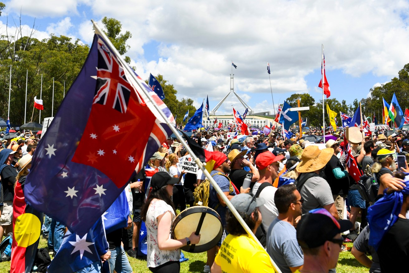 Thousands of people take part in a ‘Convoy to Canberra’ protest outside Parliament House in Canberra, Saturday.  (AAP Image/Lukas Coch) 