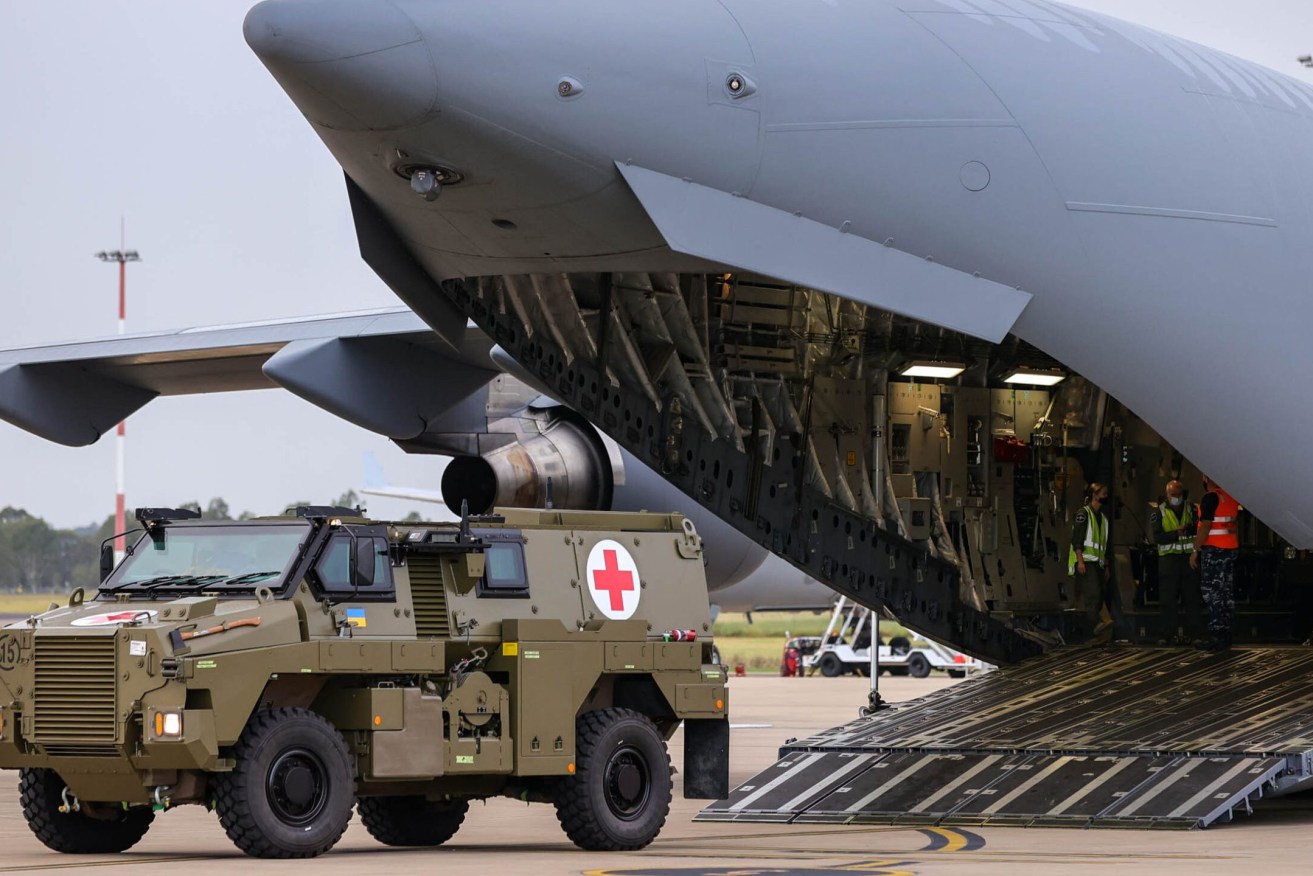 A Bushmaster PMV is loaded into a C-17 Globemaster which is headed for Ukraine. (AAP Image/Russell Freeman)