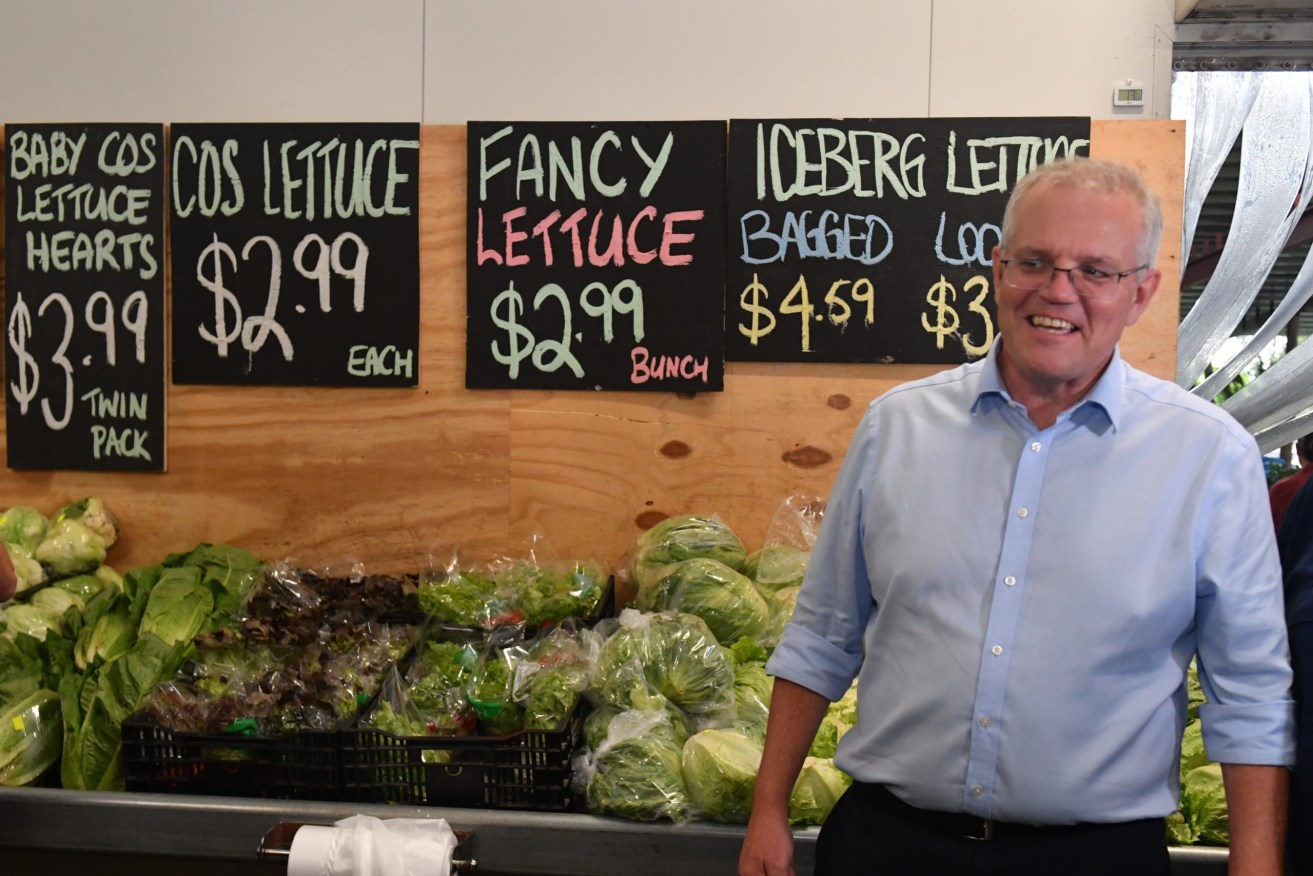Prime Minister Scott Morrison during a visit to Doblo’s Fruit Market in Rockhampton, in the seat of Capricornia. (AAP Image/Mick Tsikas) 