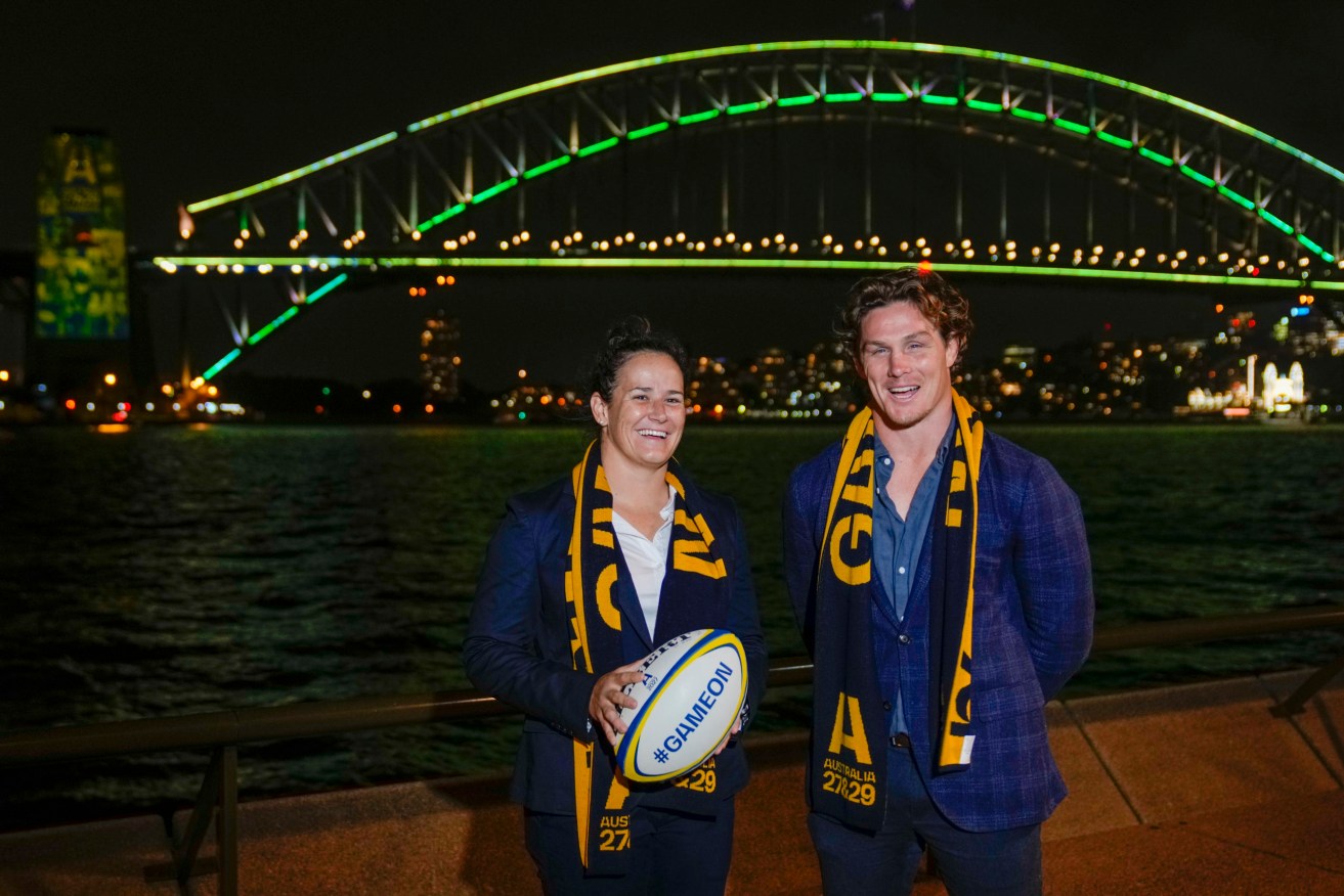 Wallabies captain Michael Hooper stands with Wallaroos captain Shannon Parry ahead of the final vote for the hosting of the Rugby World Cups in Sydney Thursday. Australia will host the 2027 men's and 2029 women's tournaments.  (AP Photo/Mark Baker)