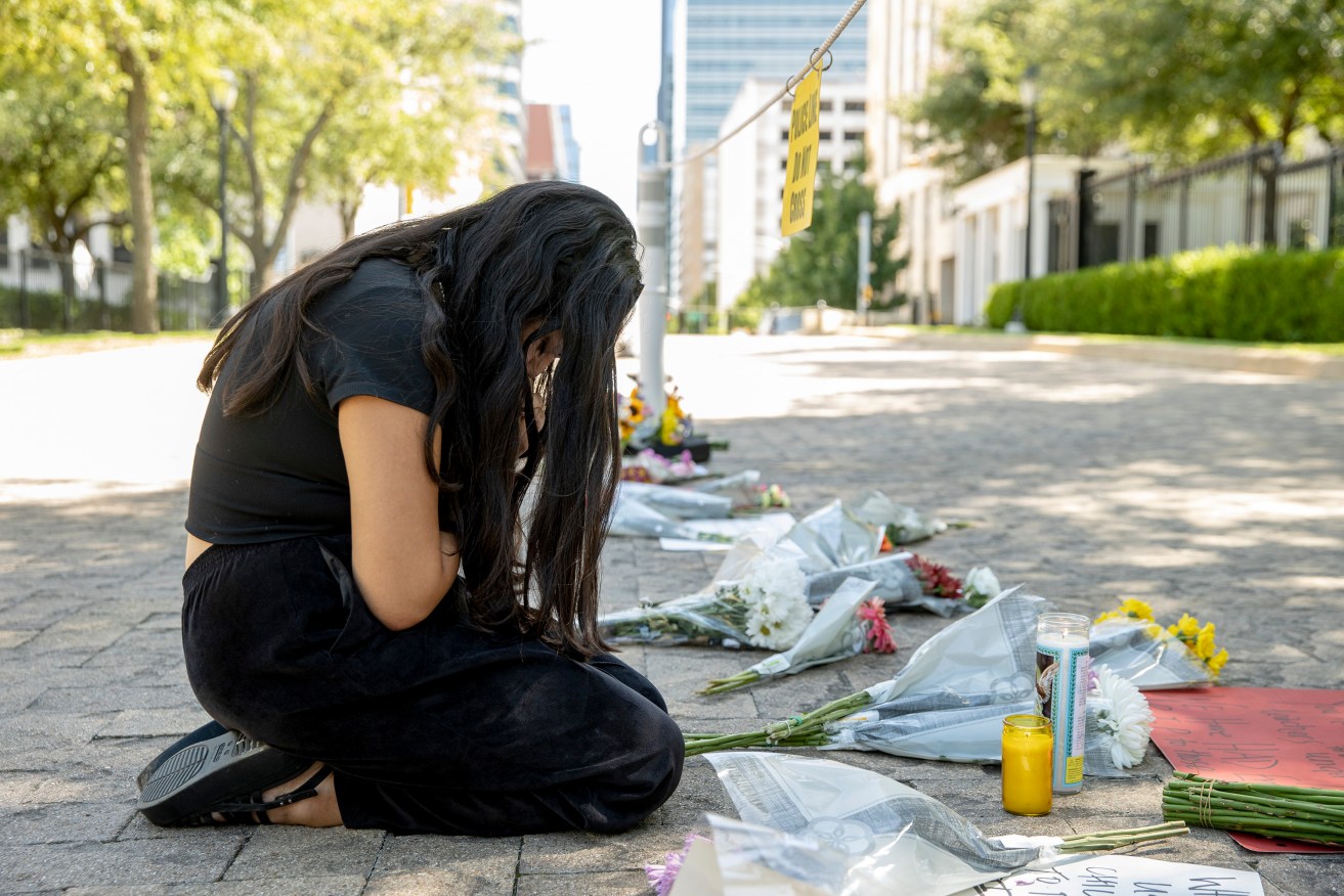 Iliana Calles prays at the Governor's Mansion, in Austin, Texas, during a protest organized by Moms Demand Action after a mass shooting at an elementary school in Uvalde, Texas. (Jay Janner/Austin American-Statesman via AP)