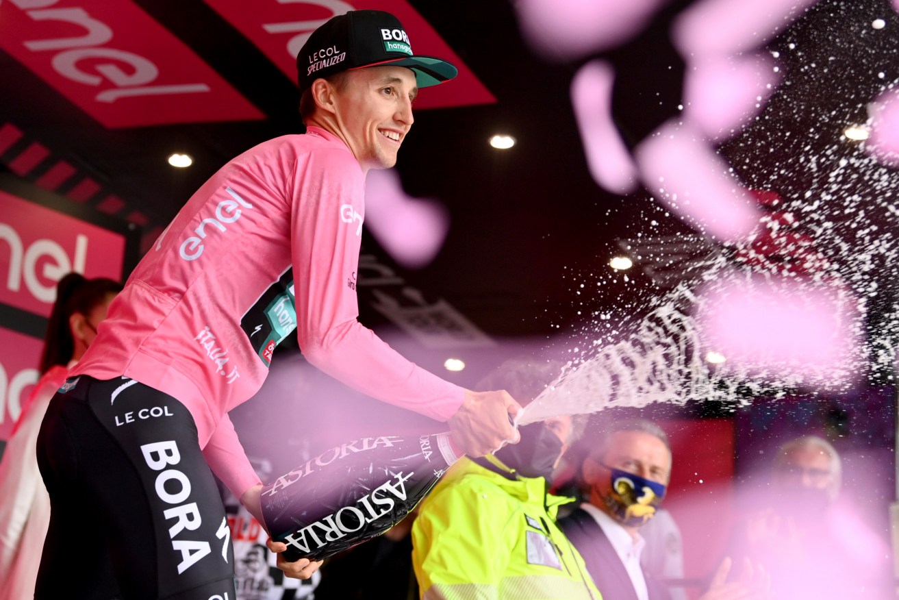 Australia's Jai Hindley wears the pink jersey as he celebrates on the podium at the end of the Giro D'Italia cycling race. (Massimo Paolone/LaPresse via AP)