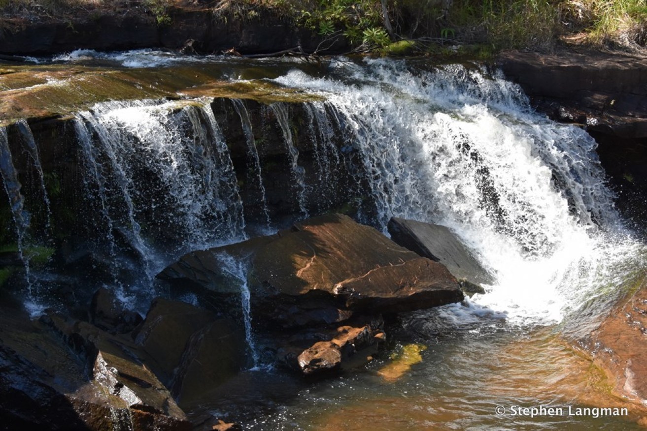 A teenager has died after slipping and falling from Isabella Falls near Cairns.l