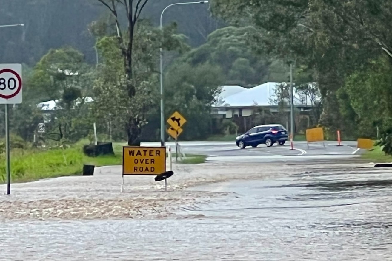 Rising floodwaters have cut off this road at Forest Glen on the Sunshine Coast. (Image: ABC)