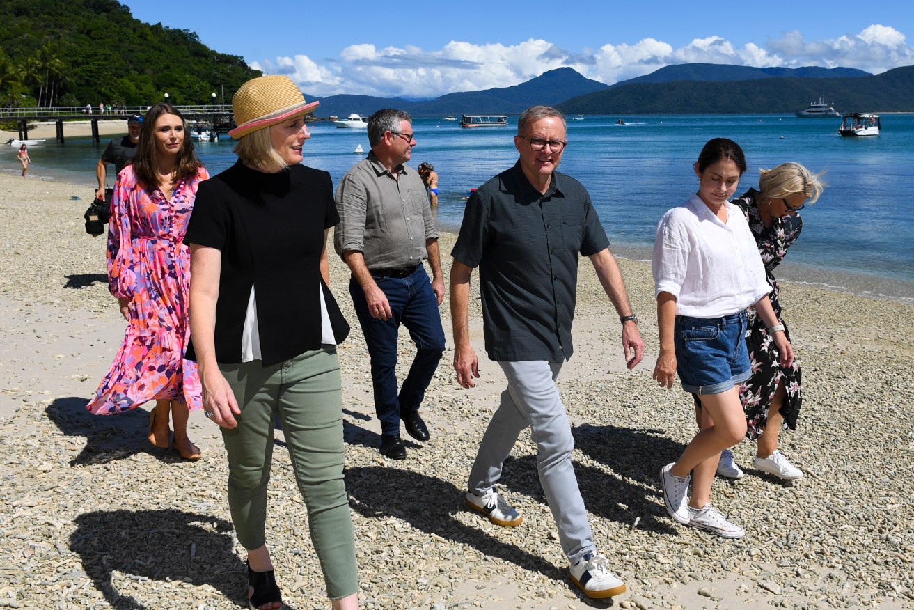 (L-R) Queensland Environment Minister Megan Scanlon, Finance Minister Katy Gallagher, Queensland Senator Murray Watt, Australian Opposition Leader Anthony Albanese, and candidates Terry Butler and Elida Faith walk along the beach at Fitzroy Island on the Great Barrier Reef . (AAP Image/Lukas Coch) 