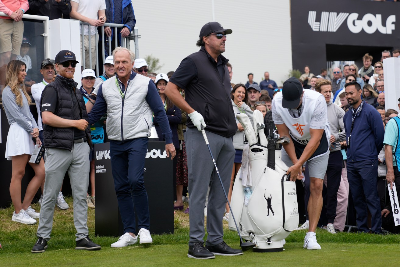 LIV Golf CEO Greg Norman joins Phil Mickelson of the United States on the first tee during the first round of the inaugural LIV Golf Invitational at the Centurion Club. (AP Photo/Alastair Grant)