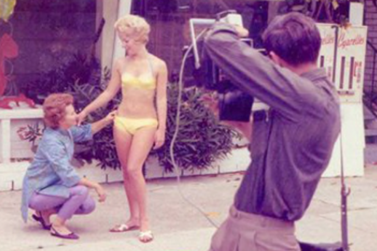 Paula Stafford with a model wearing one of her bikinis in Surfers Paradise in the '60s.(Supplied: Alan A Richards, City of Gold Coast Libraries Local Studies Collection - ABC)
