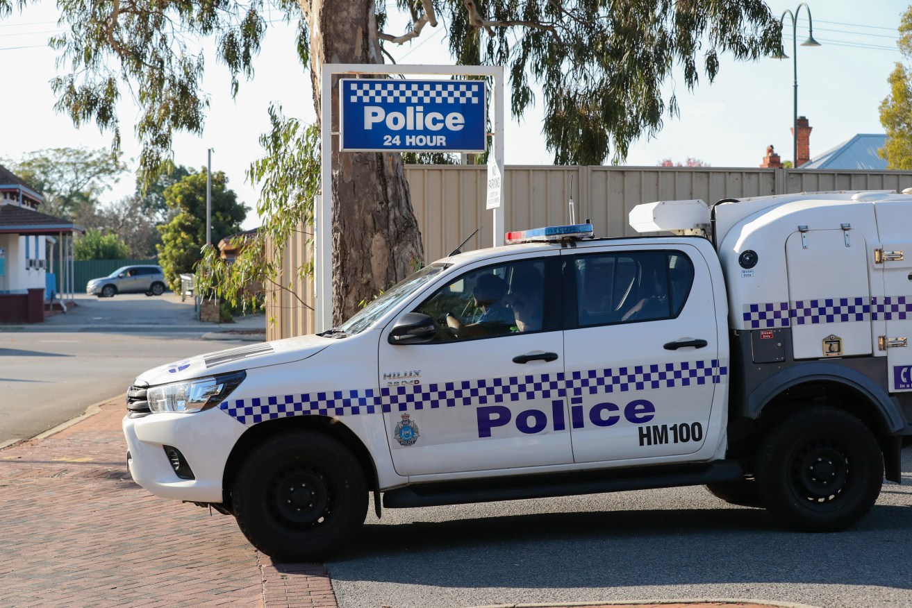 A WA Police car is seen leaving a police station in Perth on Thursday, May 17, 2018. (AAP Image/Richard Wainwright) 