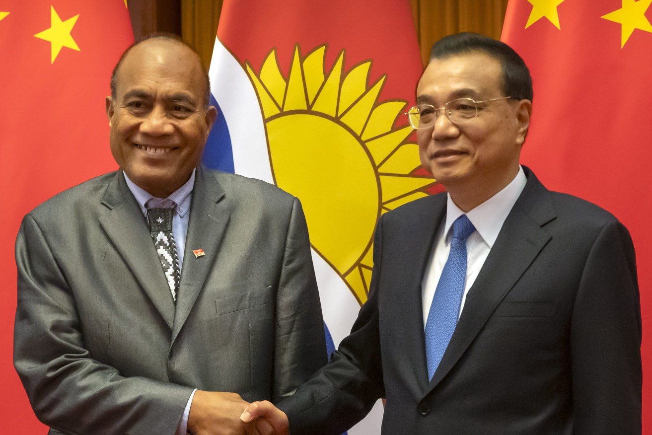 FILE - Kiribati's President Taneti Maamau, left, and Chinese Premier Li Keqiang pose for a photo before a meeting at the Great Hall of the People in Beijing, Monday, Jan. 6, 2020. China wants 10 small Pacific nations to endorse a sweeping agreement covering everything from security to fisheries in what one leader warns is a “game-changing” bid by Beijing to wrest control of the region. (AP Photo/Mark Schiefelbein, Pool, File)
