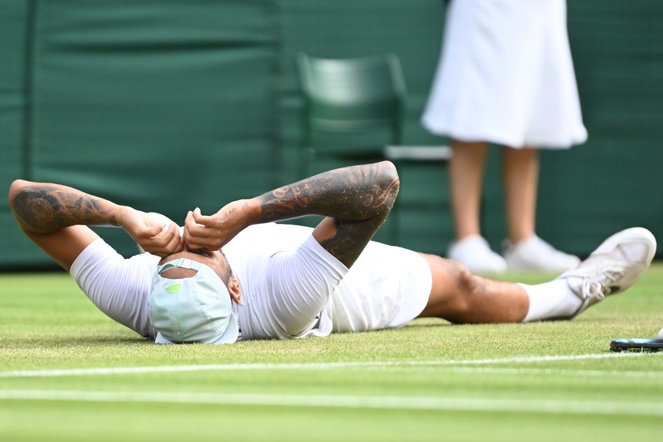 Nick Kyrgios reacts after winning in the men's quarter final match against Cristian Garin of Chile at the Wimbledon Championships.  EPA/NEIL HALL 