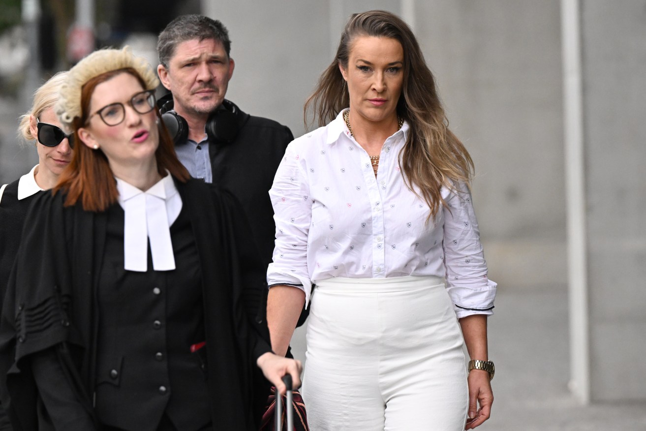 Rebecca Louise Burden (right) is facing court charged with attempted murder after she allegedly tried to suffocate her father. (AAP Image/Darren England) 