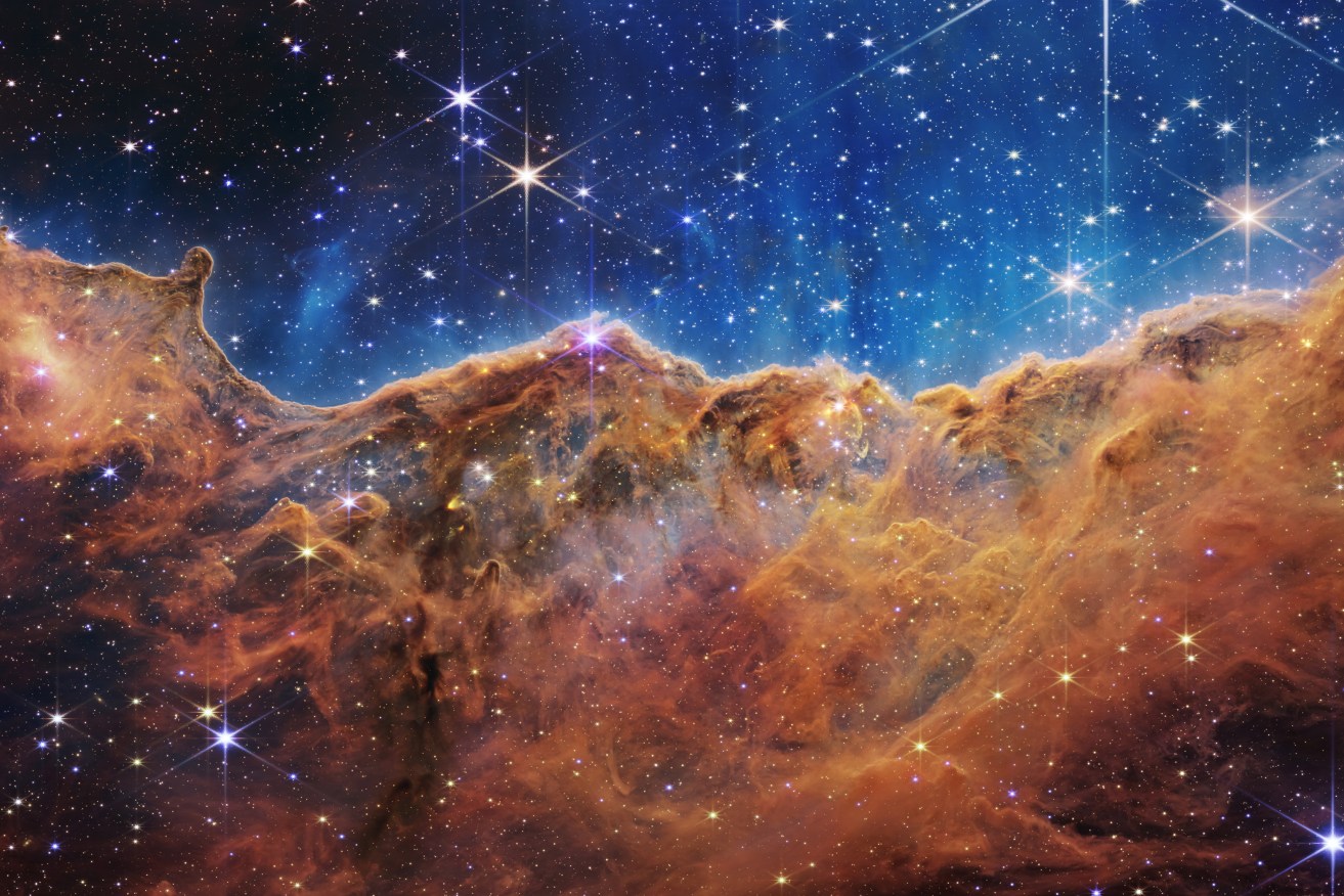 A handout photo made available by the NASA shows the edge of a nearby, young, star-forming region called NGC 3324 in the Carina Nebula, captured in infrared light by NASA’s new James Webb Space Telescope and released on 12 July 2022. This image reveals for the first time previously invisible areas of star birth.  EPA/NASA
