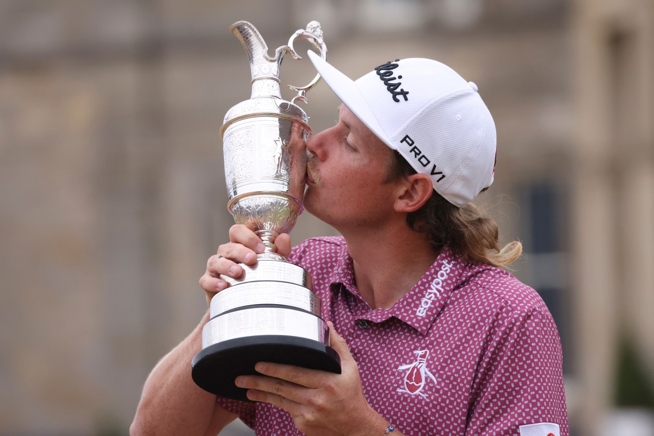 Cameron Smith, of Australia, kisses the claret jug trophy as he poses for photographers on the 18th green after winning the British Open golf Championship on the Old Course at St. Andrews, Scotland, Sunday July 17, 2022. (AP Photo/Peter Morrison) He will attempt to defend the title this week.,