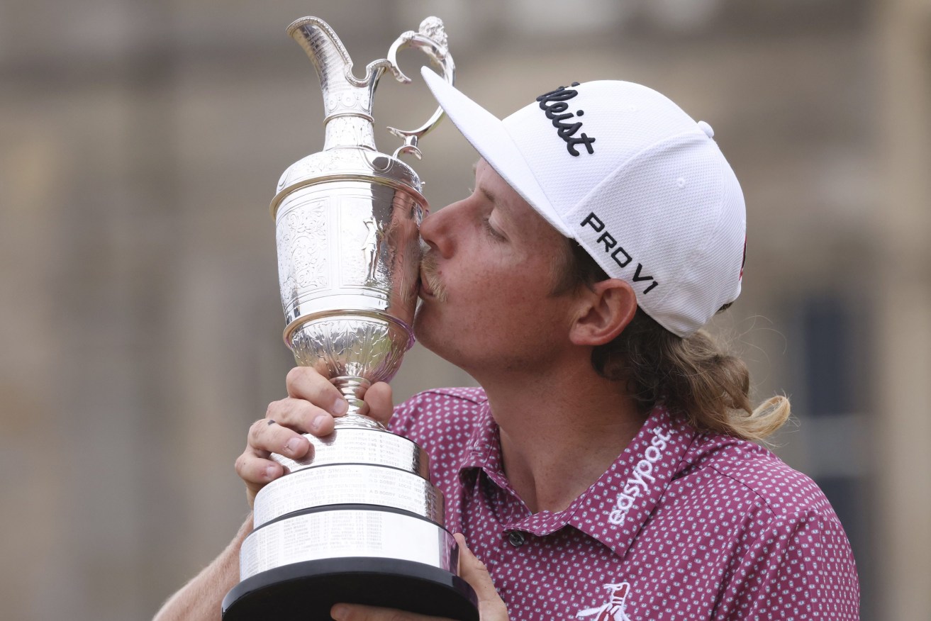 Queenslander Cameron Smith kisses the claret jug trophy as he poses for photographers on the 18th green after winning the British Open golf Championship on the Old Course at St. Andrews, Scotland, (AP Photo/Peter Morrison)