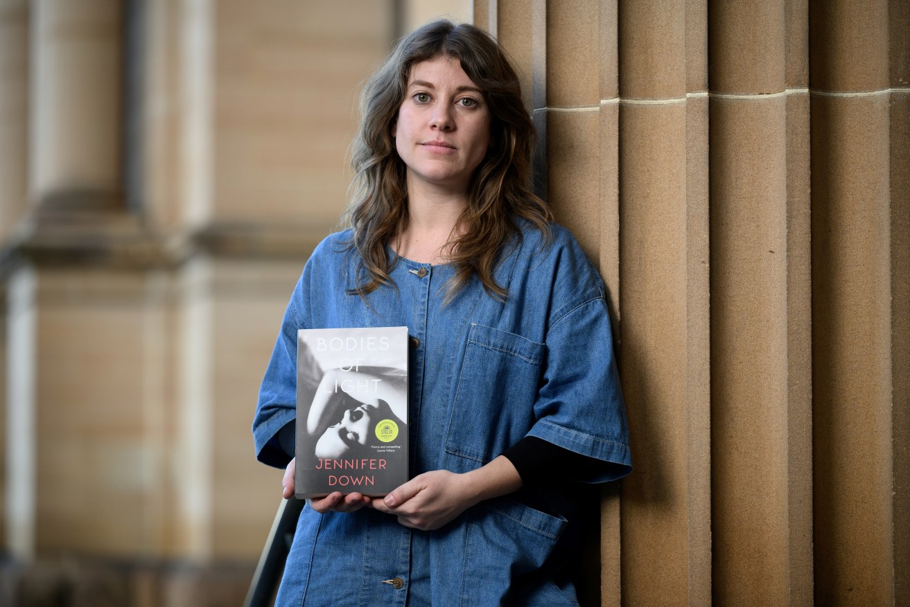 Australian author Jennifer Down with her novel Bodies of Light which won the 2022 Miles Franklin Award. (AAP Image/Dan Himbrechts) 