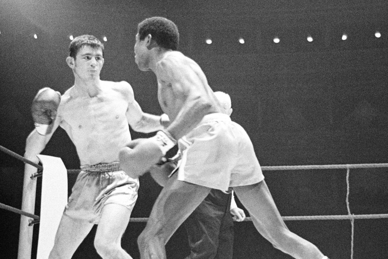 Cuban-born Spaniard Jose Legra, right, attempts to land a left hook to the head of Australian boxer Johnny Famechon during their World Featherweight Title fight, at the Royal Albert Hall, London, Jan. 21, 1969. Famechon won the title on a points decision. (AP)