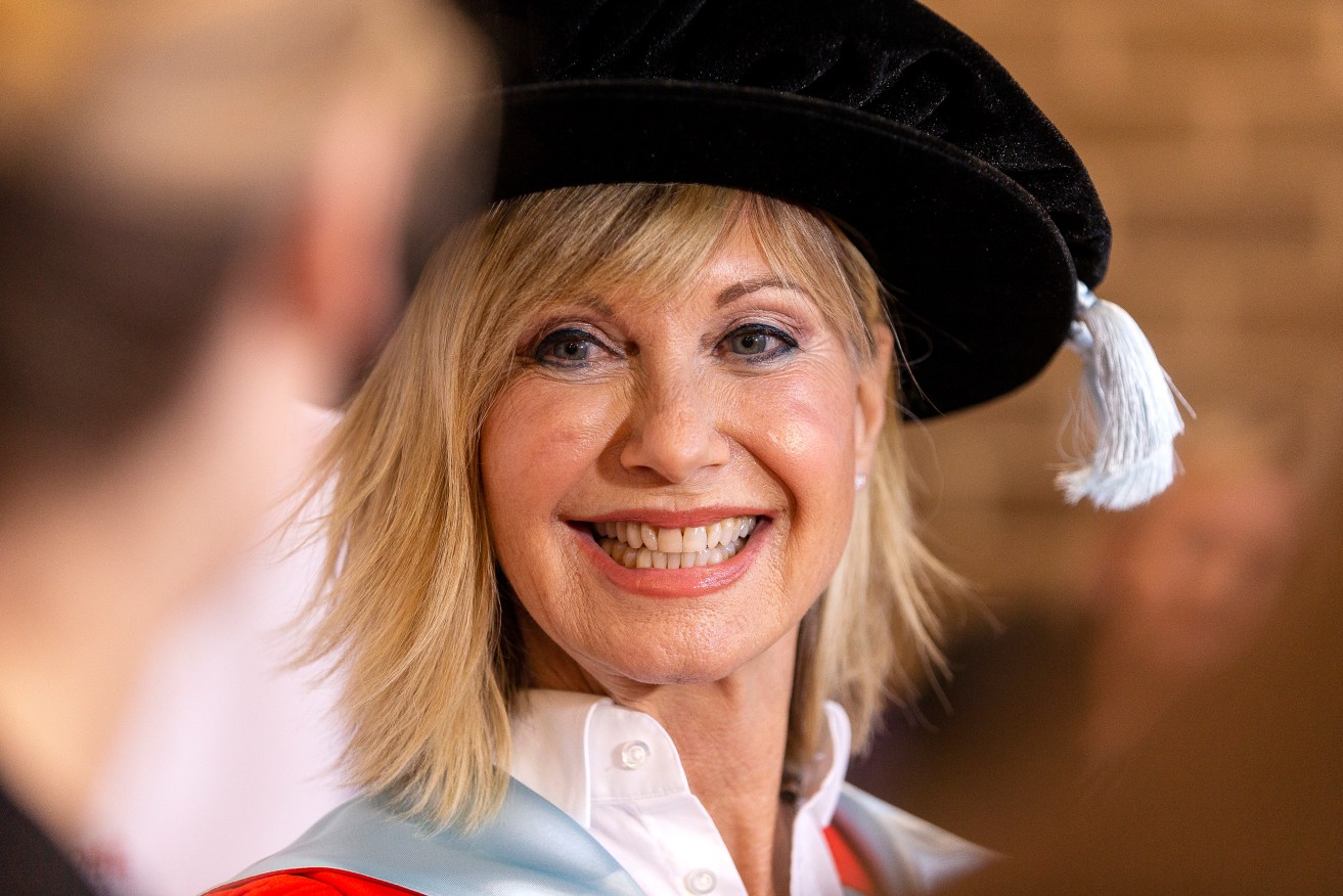 Olivia Newton-John talks to the media ahead of receiving an Honorary Doctorate of Letters at a special graduation ceremony at La Trobe University, Union Hall, Melbourne in 2018. (AAP Image/Daniel Pockett) 