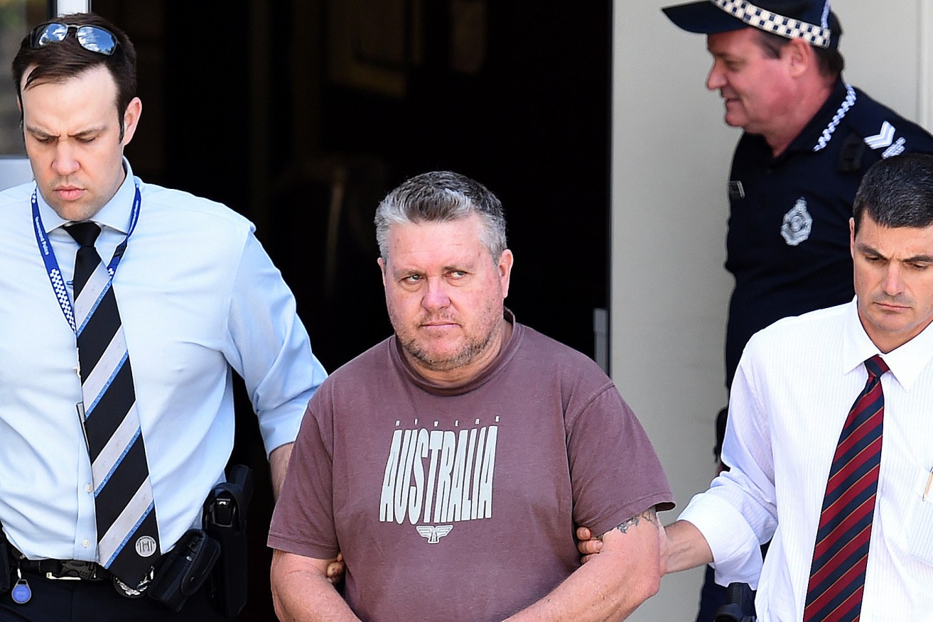 Rick Thorburn being escorted by police from the Logan Central Police Station, Queensland. (AAP Image/Dave Hunt) 