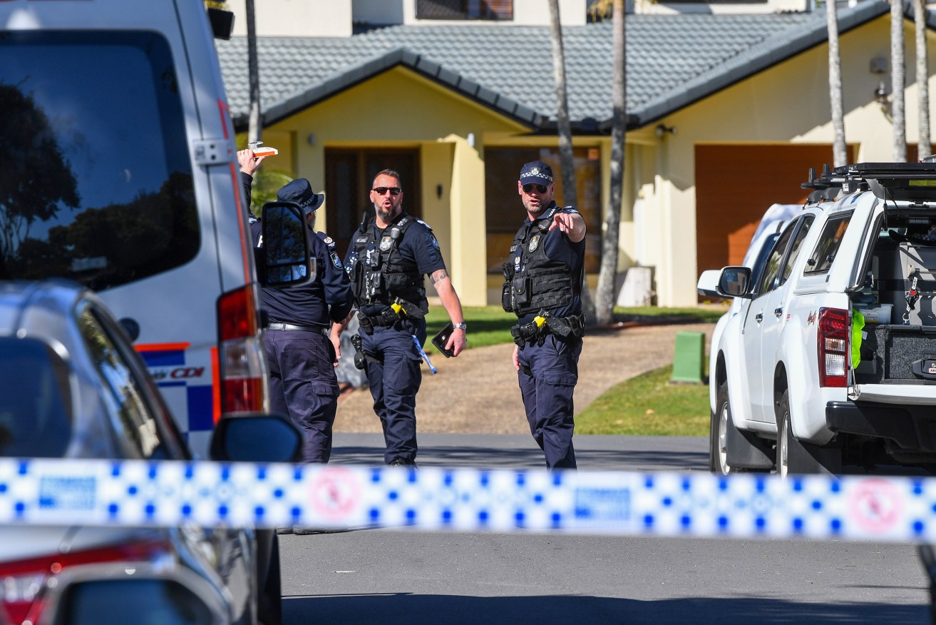 Police are seen at a crime scene at a house in the suburb of Stretton in Brisbane, Monday. Homicide detectives have launched an investigation after two people were located deceased. (AAP Image/Jono Searle) 