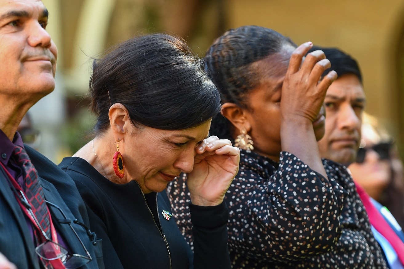 Minister for Communities and Housing Leeanne Enoch and Member for Cook Cynthia Lui show emotion during the signing of an Indigenous Treaty commitment statement at Parliament House in Brisbane, Tuesday. (AAP Image/Jono Searle) 