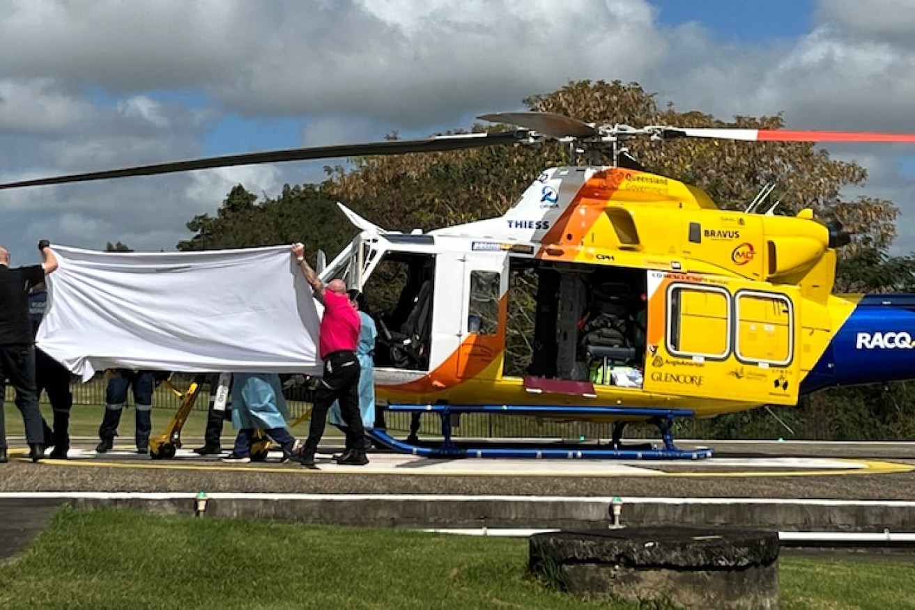 One seriously wounded victim is unloaded from the RACQ CQ Rescue chopper at Mackay Hospital. (ABC News).