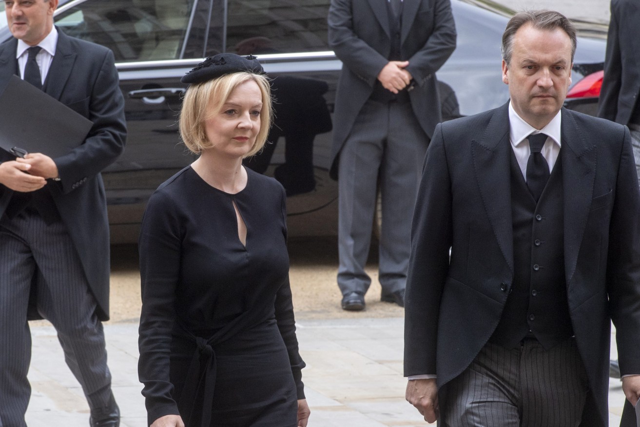 British Prime Minister Liz Truss and her husband Hugh O'Leary arrive for the funeral service of Queen Elizabeth II at Westminster Abbey in central London, Monday Sept. 19, 2022. (Geoff Pugh/Pool via AP)