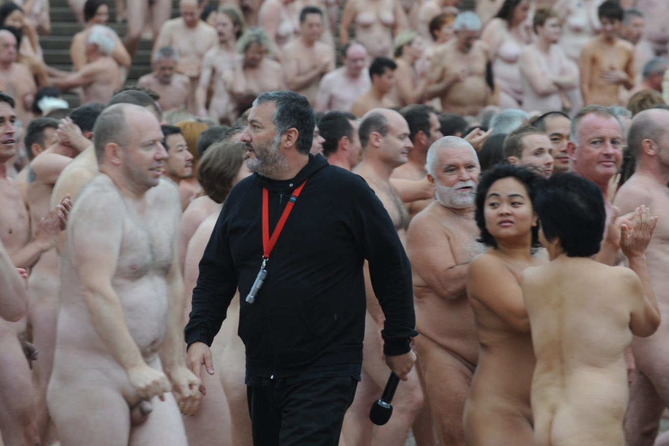 Photographer Spencer Tunick walks amongst the more than 5000 Sydneysiders who turned up to pose nude on the steps of the Sydney Opera House, Sydney, Monday, March 1, 2010.  (AAP Image/Dean Lewins) 