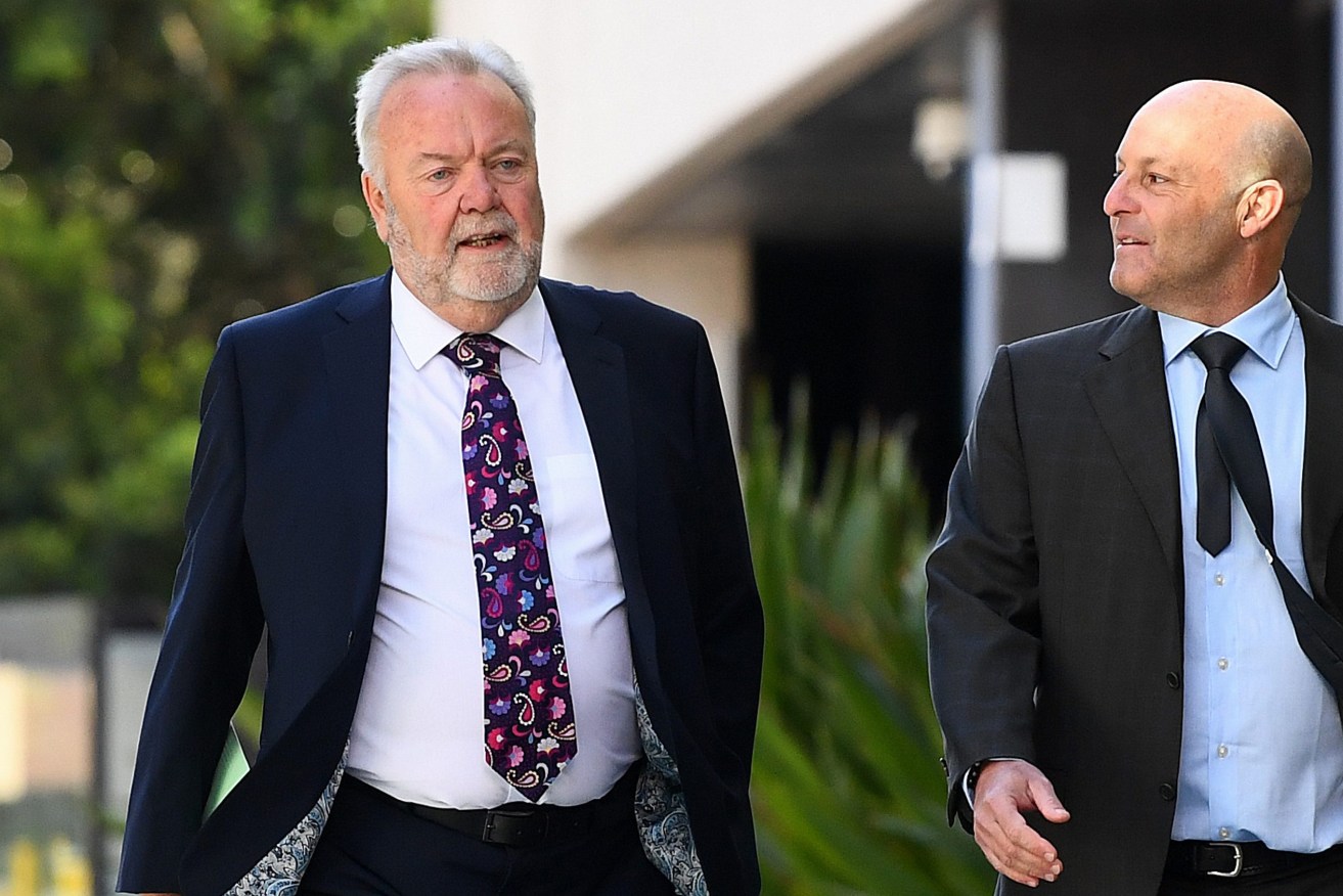 Malcolm Stamp (left) arrives at the Brisbane Magistrates Court in Brisbane. Former hospital boss Stamp is facing corruption charges in court after an alleged nepotism scandal involving his daughter. (AAP Image/Jono Searle) 