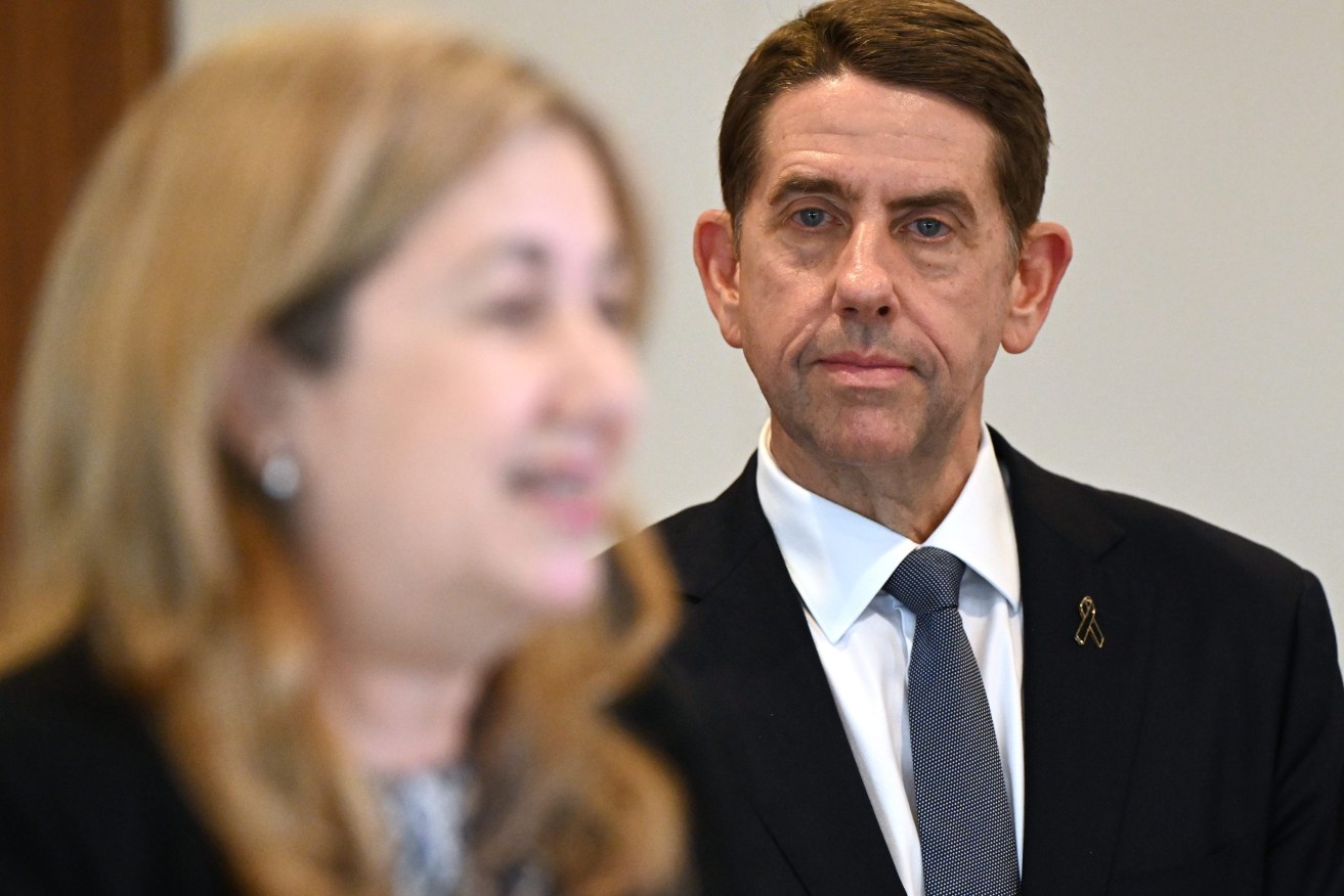 Queensland Treasurer Cameron Dick (right) looks on as Premier Annastacia Palaszczuk (left) addresses a press conference .  (AAP Image/Darren England