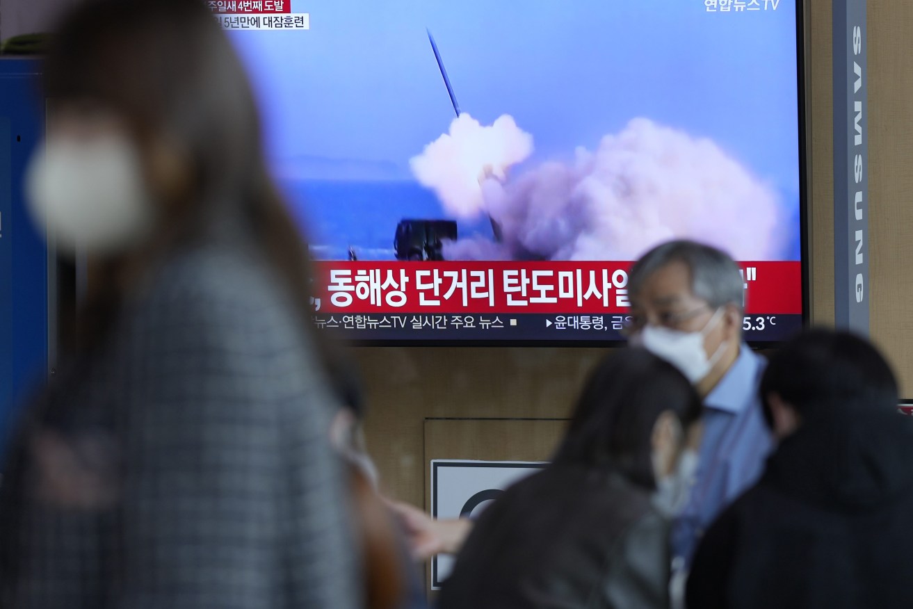 A TV screen showing a news program reporting about North Korea's missile launch with file footage. On Saturday, North Korea fired two short-range ballistic missiles toward its eastern waters, South Korean and Japanese officials said, making it the fourth round of weapons launches this week that are seen as a response to military drills among its rivals. (AP Photo/Lee Jin-man)