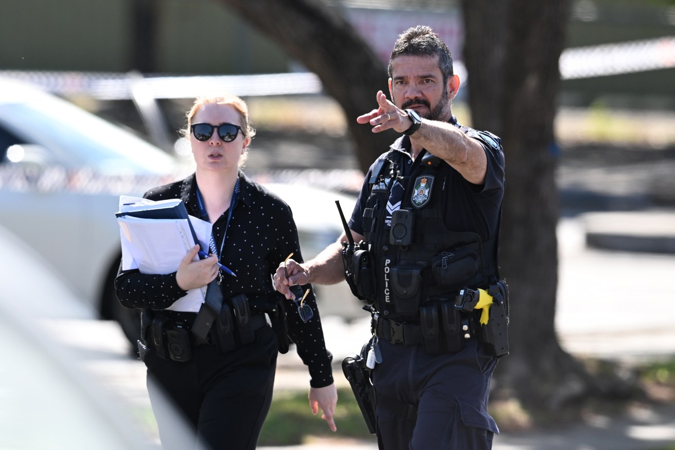 Police are seen at the scene of a fatal shooting in Oxley. (AAP Image/Darren England) 