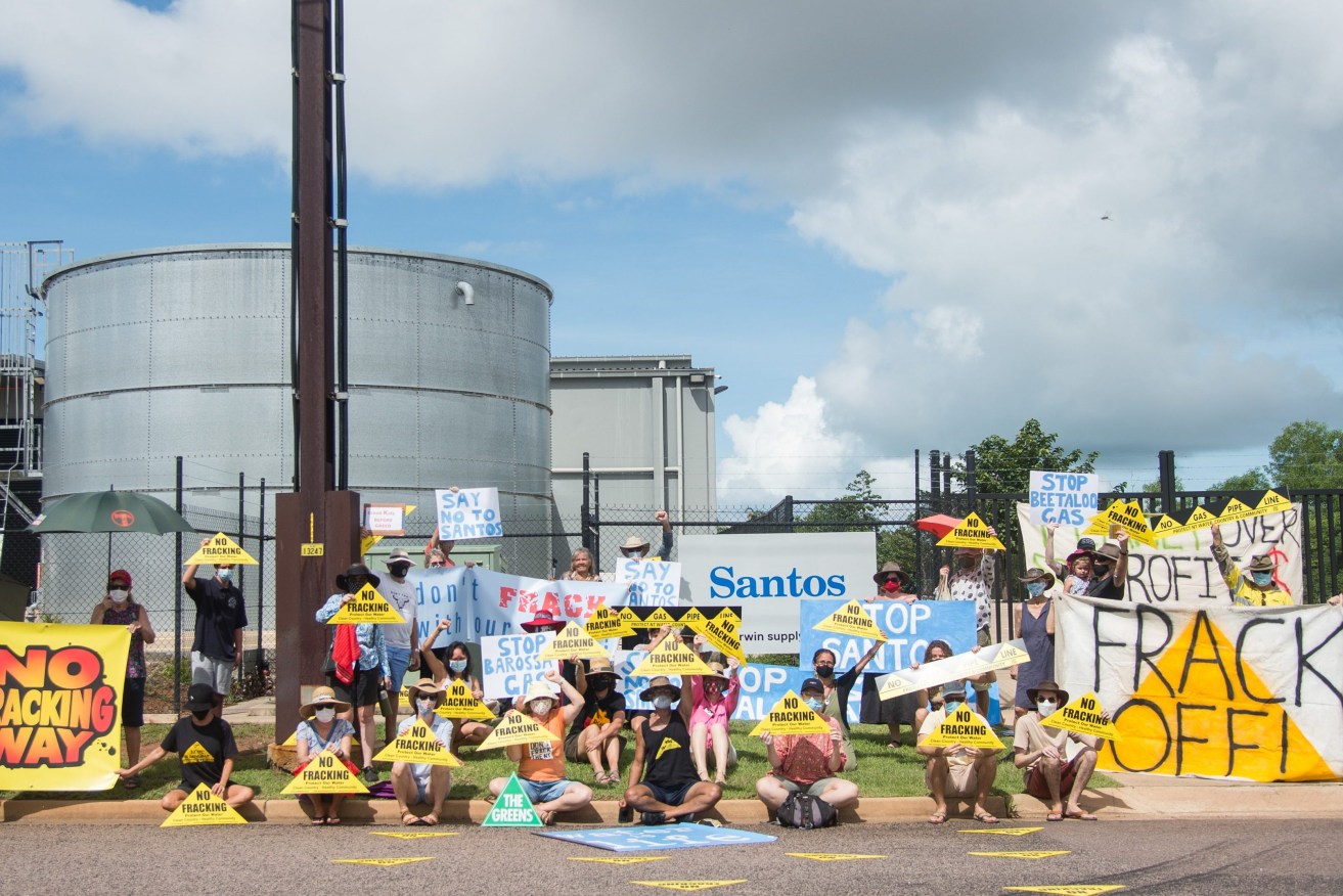 Protesters gathered outside Santos's East Arm premises to voice their concerns over the gas producer's Northern Territory projects, in Darwin. Protesters say the nation's second-largest independent gas producer is attempting to greenwash its Northern Territory gas project. (AAP Image/Aaron Bunch) 