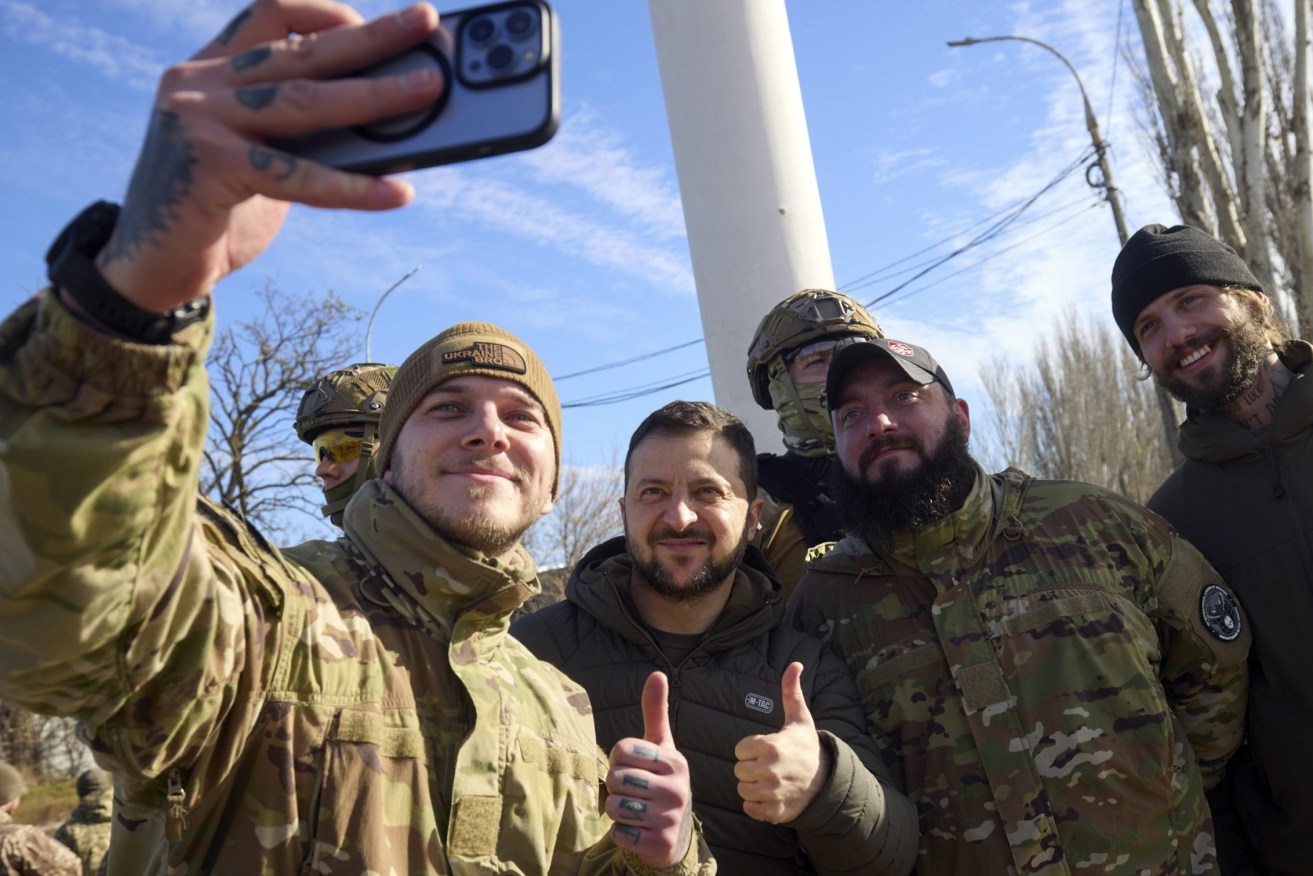 Ukrainian President Volodymyr Zelensky (C) posing for a selfie with servicemen as he visits the recaptured city of Kherson, Ukraine.  EPA/UKRAINE PRESIDENTIAL PRESS SERVICE