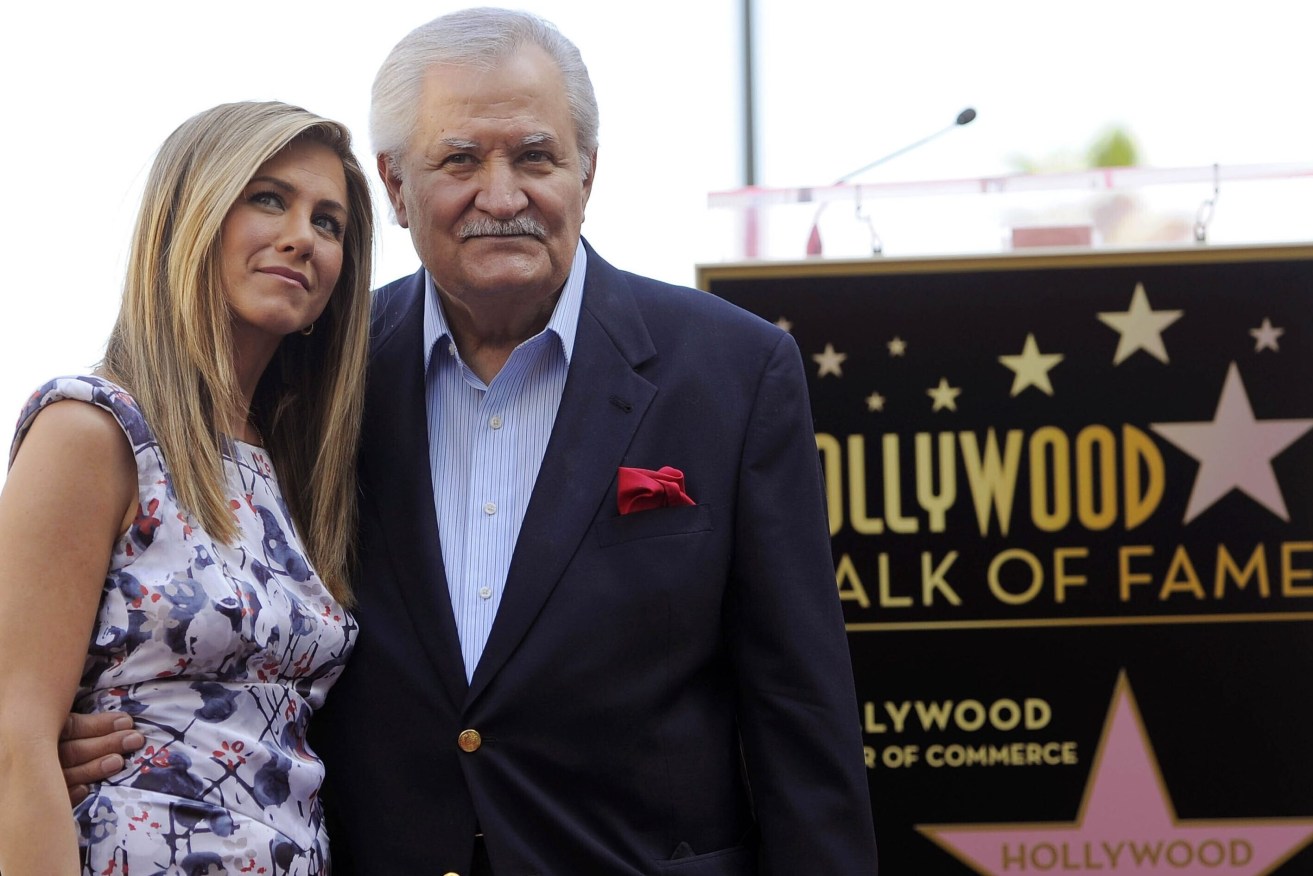 FILE - Actress Jennifer Aniston, left, poses with her father, actor John Aniston, after she received a star on the Hollywood Walk of Fame in  2012. John Aniston, the Emmy-winning star of the daytime soap opera “Days of Our Lives” and father of Jennifer Aniston, has died at age 89.  (AP Photo/Chris Pizzello, File)
