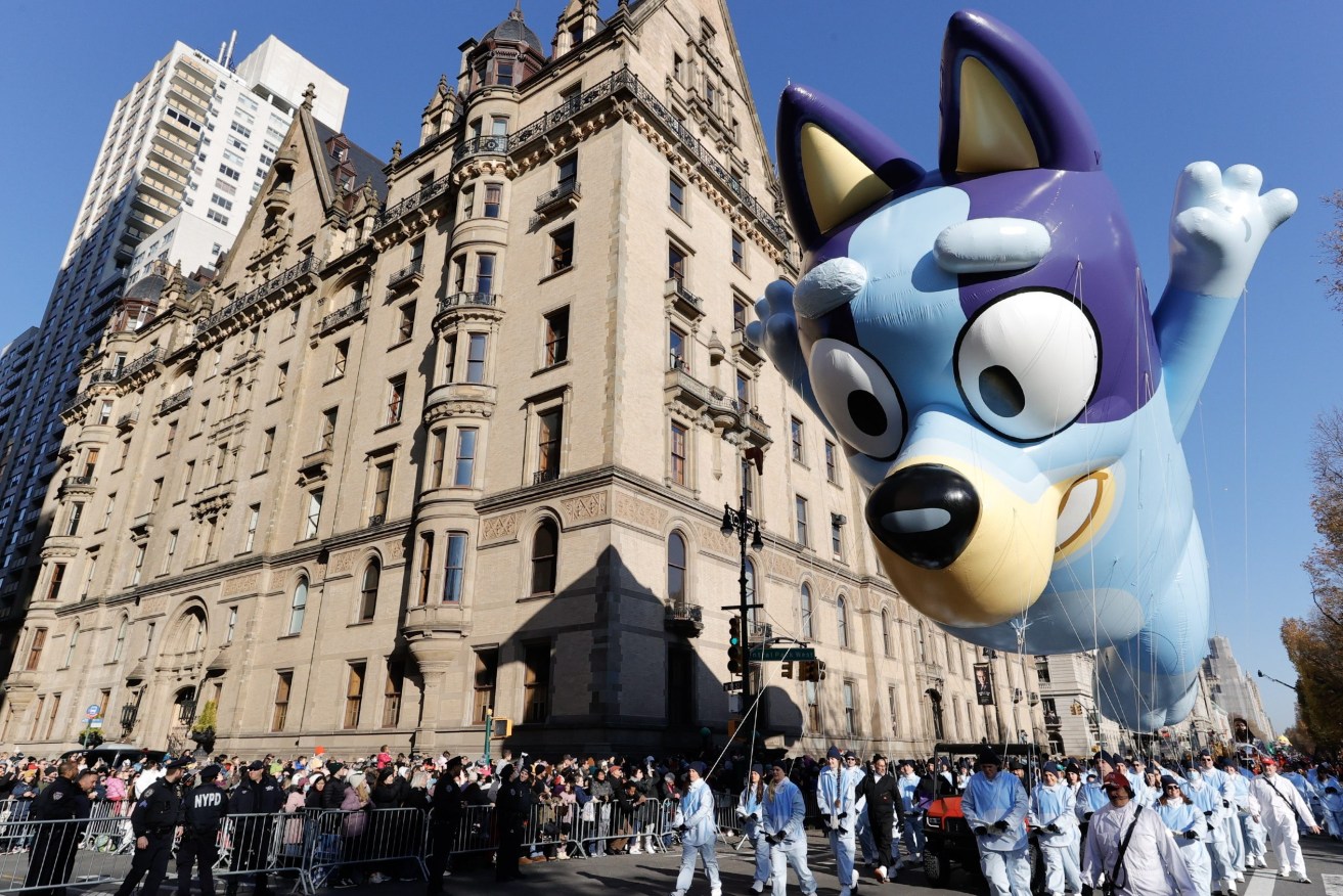 The Bluey balloon floats past The Dakota Building along Central Park West during the Macy's Annual Thanksgiving Day Parade in New York City. (EPA/JASON SZENES)
