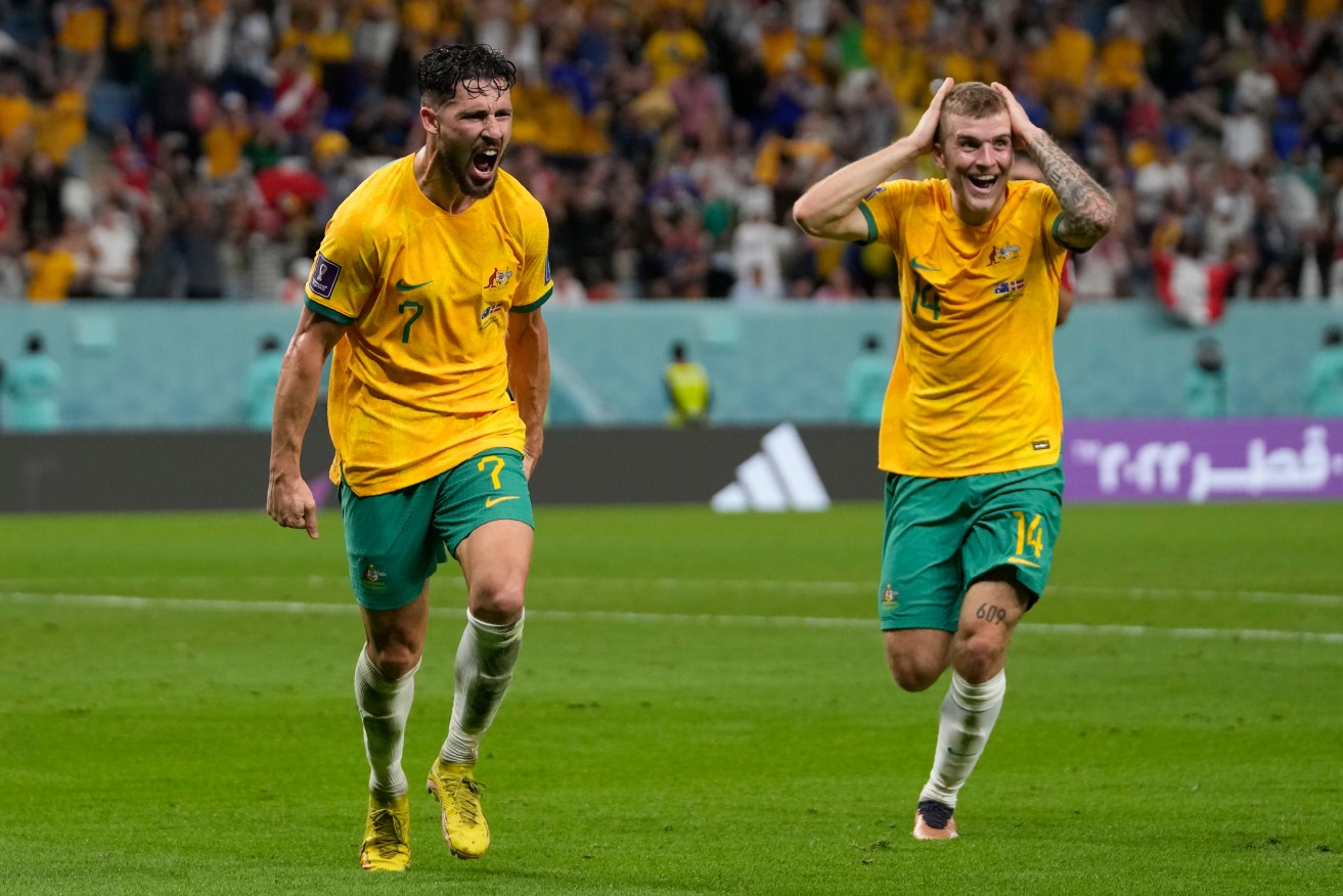Australia's Mathew Leckie, left, celebrates with his teammate Riley McGree after scoring his side's first goal during the World Cup group D soccer match between Australia and Denmark, at the Al Janoub Stadium in Qatar,. (AP Photo/Thanassis Stavrakis)