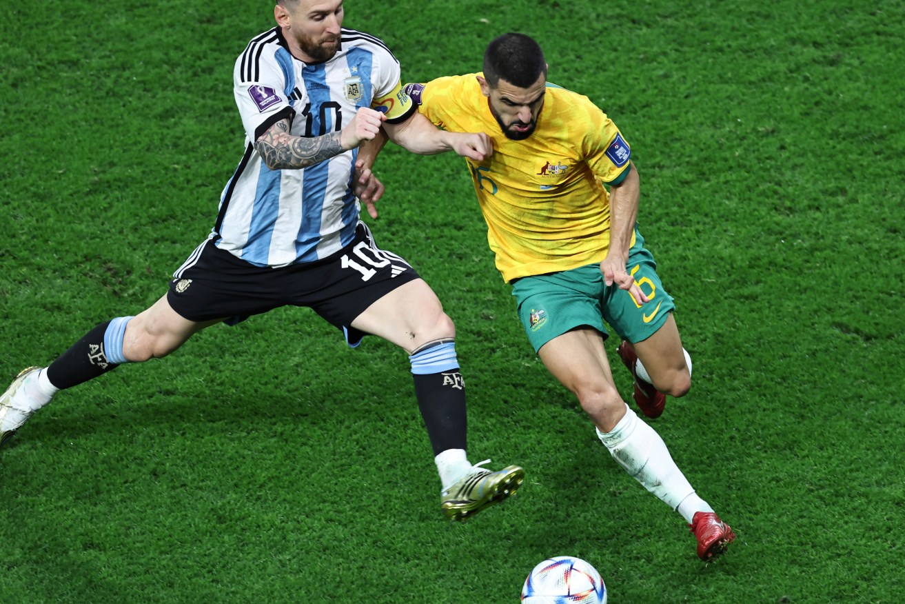 Argentine superstar Lionel Messi (L) fights for the ball against Australia's Aziz Behich (R) during the Qatar 2022 World Cup football match.  Argentina beat Australia 2-1 and will play the Netherlands in the quarter-finals on Friday.(Photo By Liu Zhankun/ColorChinaPhoto) Color China Photo/AP Images