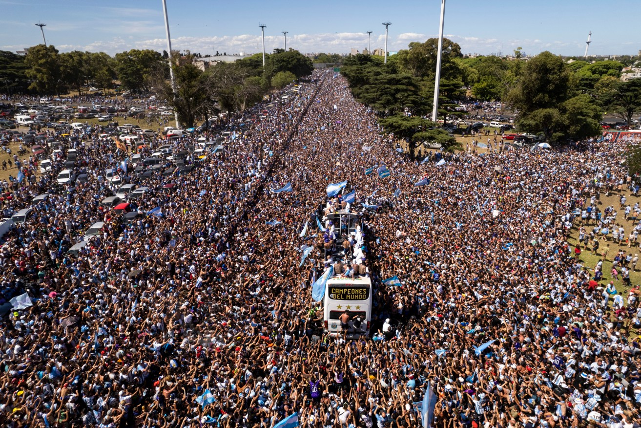 The Argentine soccer team that won the World Cup title ride on an open bus during their homecoming parade in Buenos Aires, Argentina, Tuesday, Dec. 20, 2022. (AP Photo/Rodrigo Abd)