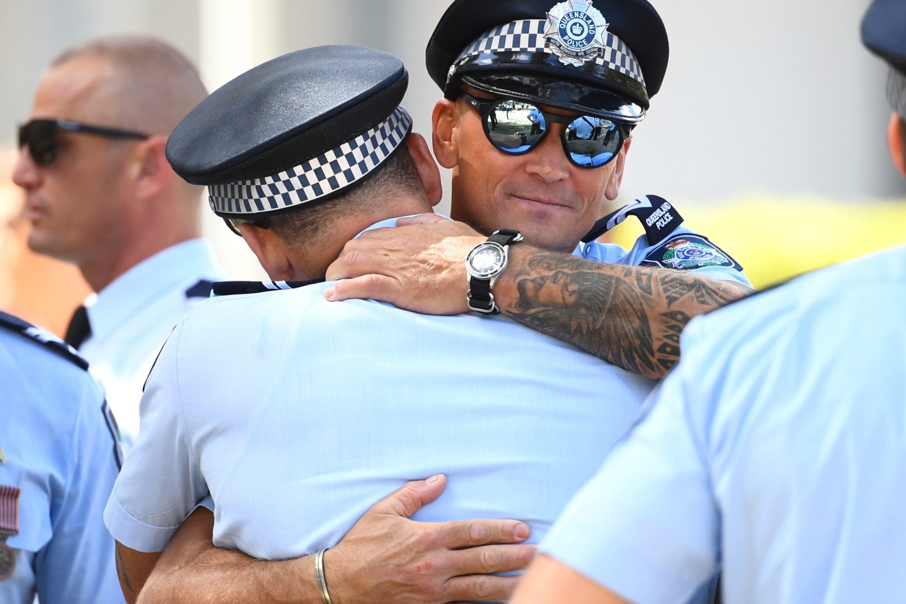 Police officers are seen arriving to a memorial service for the two police constables killed in the Wieambilla shooting tragedy, at the Brisbane Entertainment Centre in Brisbane, Wednesday, December 21, 2022. (AAP Image/Jono Searle) 