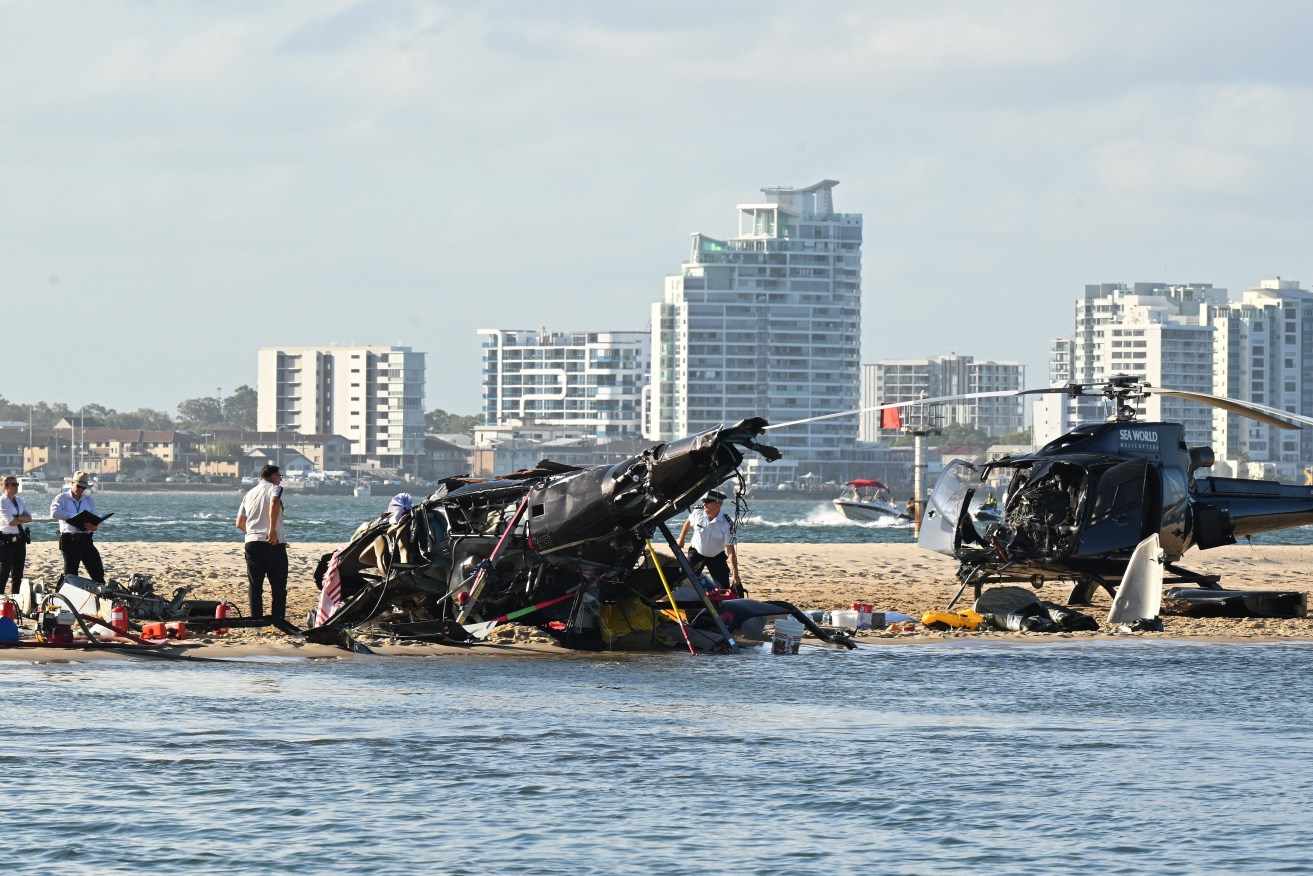 Four people died and another 13 were injured after two helicopters collided before one crashed into the Broadwater on the Gold Coast. (AAP Image/Dave Hunt) 