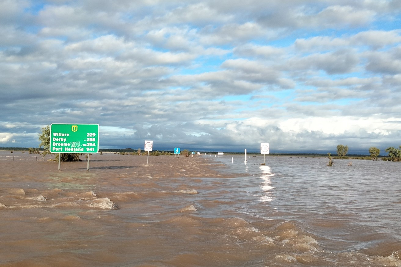 Floodwaters across the Great Northern Hwy at Fitzroy Crossing, Bunuba country, in the Kimberley region of Western Australia. A remote Western Australian town surrounded by a 100-year flood has become a refuge for hundreds of people evacuated from outlying communities.(AAP Image/Supplied by Andrea Myers) 
