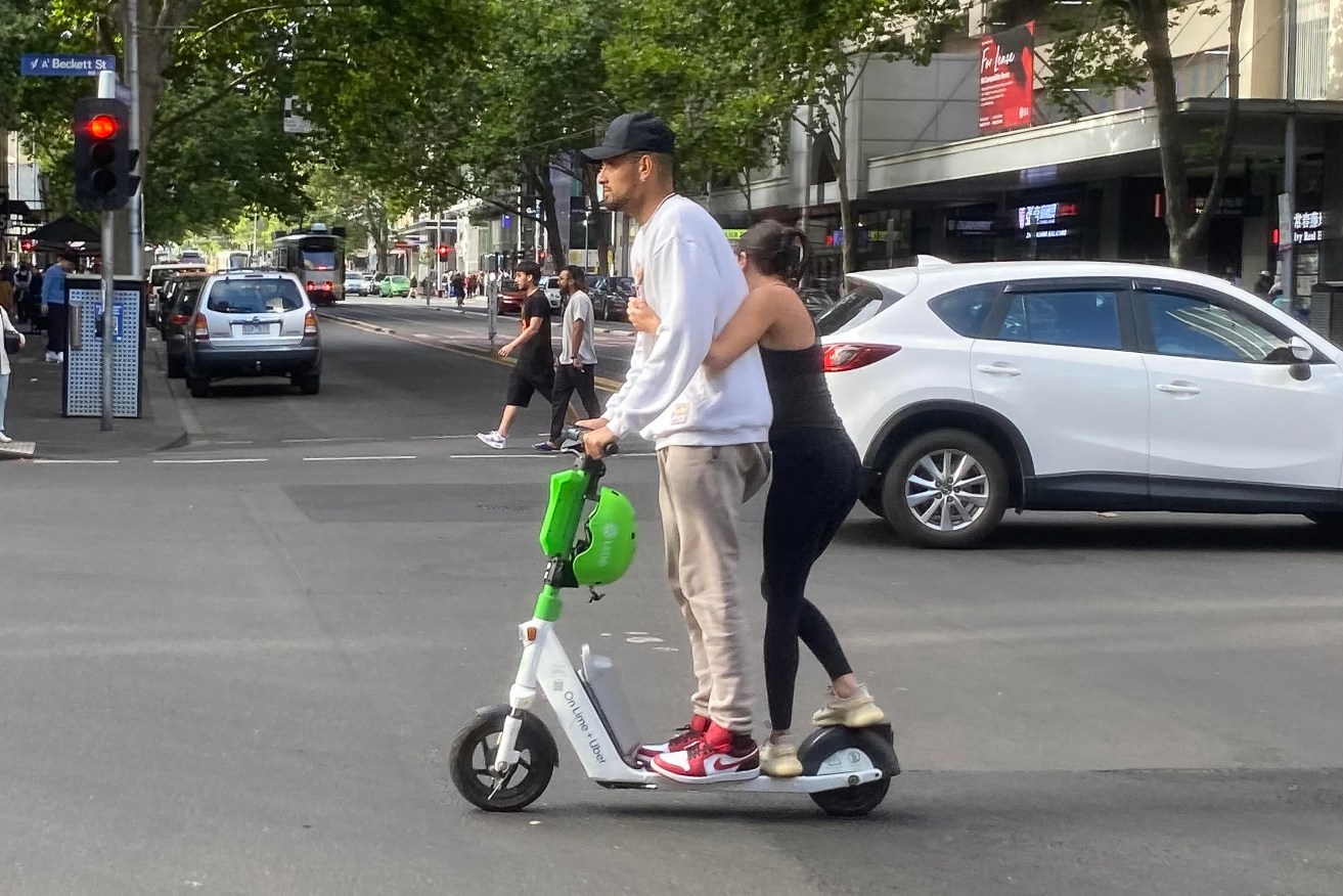 Australian tennis player Nick Kyrgios riding a e-scooter on Elizabeth street in Melbourne. (AAP Image/James Ross) 